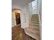 Inviting staircase leading to the upper level with carpeted steps and wood-look flooring at 3938 E Chaffe Ave, Pahrump, NV 89061