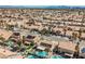 Extensive view of a residential neighborhood with pools, desert landscaping, and solar panels at 3961 Equinox Ct, Las Vegas, NV 89147