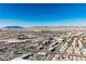 Expansive aerial view showcasing the neighborhood, nearby mountains, and clear blue sky at 3961 Equinox Ct, Las Vegas, NV 89147