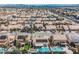 Extensive view of a neighborhood showcasing homes, palm trees, pools, and solar panels at 3961 Equinox Ct, Las Vegas, NV 89147