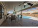 Covered back patio with table and chairs next to a backyard pool at 3961 Equinox Ct, Las Vegas, NV 89147