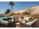 Backyard with a fire pit surrounded by seating and pool in the background at 3961 Equinox Ct, Las Vegas, NV 89147
