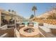 Backyard with a fire pit surrounded by seating and pool with waterfall at 3961 Equinox Ct, Las Vegas, NV 89147