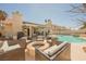 Backyard with a fire pit surrounded by seating, covered patio and pool with waterfall at 3961 Equinox Ct, Las Vegas, NV 89147