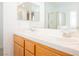 Well-lit bathroom featuring double sinks, large mirrors, and glass enclosed shower at 3961 Equinox Ct, Las Vegas, NV 89147