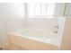 Bright bathroom featuring a soaking tub and large window for natural light at 3961 Equinox Ct, Las Vegas, NV 89147