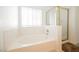 Bright bathroom featuring a soaking tub, shower, and large window for natural light at 3961 Equinox Ct, Las Vegas, NV 89147