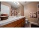 Bathroom featuring neutral carpet, cabinet vanity, and tile counter at 3961 Equinox Ct, Las Vegas, NV 89147
