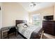 Bright bedroom with a dark wood frame bed, desk, dresser, and nice outdoor view at 3961 Equinox Ct, Las Vegas, NV 89147