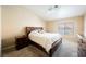 Spacious bedroom features a queen-sized bed, ceiling fan, and natural light at 3961 Equinox Ct, Las Vegas, NV 89147