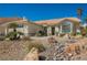 Attractive one-story home with desert landscaping featuring rocks, stones, and mature palm trees at 3961 Equinox Ct, Las Vegas, NV 89147