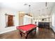 Entertain in style in this game room with a billiard table, wet bar, and view to the living room at 3961 Equinox Ct, Las Vegas, NV 89147