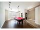 Spacious game room featuring a billiard table, wood floors, and decorative lighting at 3961 Equinox Ct, Las Vegas, NV 89147