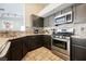 A kitchen showcasing gray cabinets, stainless steel appliances, and granite countertops, complete with tile flooring at 3961 Equinox Ct, Las Vegas, NV 89147