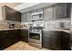 A kitchen showcasing gray cabinets, stainless steel appliances, and granite countertops, complete with tile flooring at 3961 Equinox Ct, Las Vegas, NV 89147
