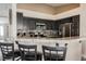 Close-up of the kitchen featuring sleek black cabinetry, stainless steel appliances, and granite countertops at 3961 Equinox Ct, Las Vegas, NV 89147