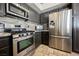Modern kitchen features stainless steel appliances, dark cabinetry, and decorative backsplash at 3961 Equinox Ct, Las Vegas, NV 89147