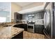 A kitchen showcasing gray cabinets, stainless steel appliances, and granite countertops, complete with tile flooring at 3961 Equinox Ct, Las Vegas, NV 89147