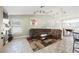 Spacious living room with a comfortable sectional sofa, unique artwork, and tile flooring at 3961 Equinox Ct, Las Vegas, NV 89147