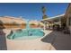 Inviting pool area with a waterfall feature, lounging spaces, and a covered patio for relaxation at 3961 Equinox Ct, Las Vegas, NV 89147