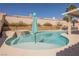 Inviting pool and spa area with waterfall feature, lounging spaces, and a covered patio at 3961 Equinox Ct, Las Vegas, NV 89147