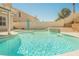Backyard pool with waterfall feature and blue water surrounded by the patio and seating areas at 3961 Equinox Ct, Las Vegas, NV 89147