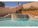 Relaxing pool waterfall feature with decorative stone steps, enhancing the backyard's ambiance at 3961 Equinox Ct, Las Vegas, NV 89147
