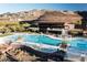 Resort-style community pool with lots of lounge chairs at 4 Kaya Canyon Way # 15, Henderson, NV 89012