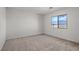 Light-filled bedroom featuring neutral carpet, neutral paint, and a large window at 4253 Gold Desert St, North Las Vegas, NV 89032