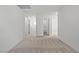 Upstairs hallway featuring neutral carpet, multiple doorways, and bright, neutral paint at 4253 Gold Desert St, North Las Vegas, NV 89032