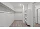 Spacious walk-in closet with built-in shelving and racks, carpeted floor and neutral paint at 4253 Gold Desert St, North Las Vegas, NV 89032