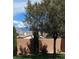 Green backyard with a brick privacy fence, shrubbery and view of nearby mountains at 4429 S Glory Vine Ln, Pahrump, NV 89061
