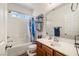 Cozy bathroom with a tub/shower combination, mirrored sink and natural light from the window above at 4429 S Glory Vine Ln, Pahrump, NV 89061