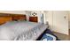 Comfortable bedroom with a wooden headboard and a view of a bathroom at 4429 S Glory Vine Ln, Pahrump, NV 89061