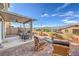 Inviting backyard with covered patio, string lights, and comfortable seating area for relaxing outdoors at 4442 Solitude Falls Ave, North Las Vegas, NV 89084