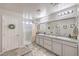 Bathroom features double sinks with a large mirror and a separate shower stall at 4442 Solitude Falls Ave, North Las Vegas, NV 89084