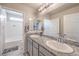 Bathroom featuring double sinks with granite countertops at 4442 Solitude Falls Ave, North Las Vegas, NV 89084