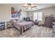 Bedroom featuring carpet, ceiling fan, natural light, and a neatly made bed at 4442 Solitude Falls Ave, North Las Vegas, NV 89084
