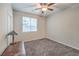 Cozy bedroom with neutral walls, ceiling fan, carpeted floors and a window with blinds at 4442 Solitude Falls Ave, North Las Vegas, NV 89084