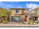 Inviting two-story home featuring a two-car garage, stone accents, and a well-maintained front yard at 4442 Solitude Falls Ave, North Las Vegas, NV 89084