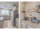 Kitchen with stainless appliances, granite counters, a beverage center, and stylish coffee bar at 4442 Solitude Falls Ave, North Las Vegas, NV 89084