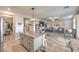 Open-concept kitchen featuring granite countertops and a central island leading into a spacious living area at 4442 Solitude Falls Ave, North Las Vegas, NV 89084