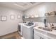 Functional laundry room with modern appliances and sink at 4442 Solitude Falls Ave, North Las Vegas, NV 89084