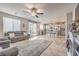 Spacious open-concept living room and kitchen with lots of natural light and stylish tile flooring at 4442 Solitude Falls Ave, North Las Vegas, NV 89084