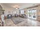 Inviting living room with tile floors, comfortable seating, and sliding door access to the patio at 4442 Solitude Falls Ave, North Las Vegas, NV 89084
