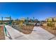 Vibrant community playground with modern play equipment and shade, perfect for Gathering fun and outdoor activities at 4442 Solitude Falls Ave, North Las Vegas, NV 89084