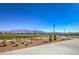 The community includes a tennis court with beautiful mountain views and clear blue skies at 4442 Solitude Falls Ave, North Las Vegas, NV 89084