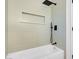 Modern bathroom featuring a shower with a rainfall showerhead and stylish subway tile at 4629 Alta Dr, Las Vegas, NV 89107