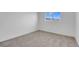 Bedroom featuring neutral carpet, white walls, and a window offering natural light at 4629 Alta Dr, Las Vegas, NV 89107
