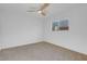 Bright bedroom with neutral carpet, a ceiling fan and a window with a view at 4629 Alta Dr, Las Vegas, NV 89107